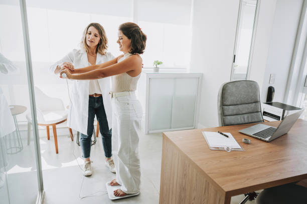 Woman tracking weight loss progress with focus on hormonal health in Dallas